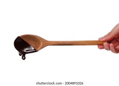 Hand Holding Chocolate Cream Wood Spoon Isolated On White Background