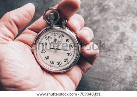 hand holding chronometer