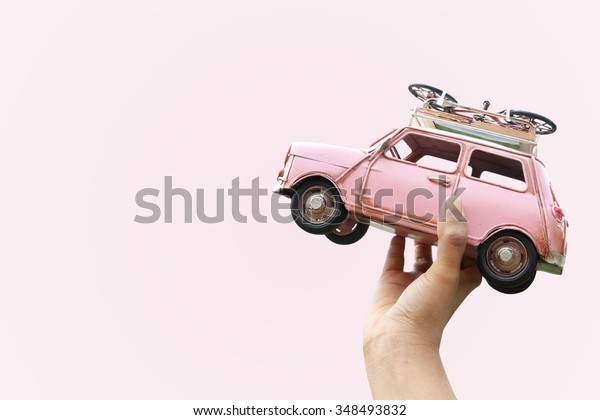 Hand holding classic mini model with bicycle,\
Travel concept