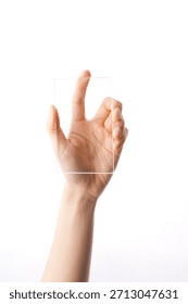 Hand holding a clear, empty rectangular object against a white background in a bright setting during daylight