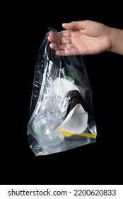 Hand Holding Clear Plastic Bag Of Garbage Isolated On White Background