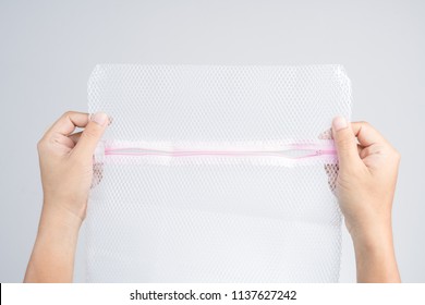 Hand Holding Cloth Bag Or Wash Net For Laundry Machine