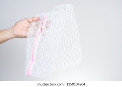 Hand Holding Cloth Bag Or Wash Net For Laundry Machine