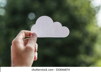 Hand holding cloud computing symbol.