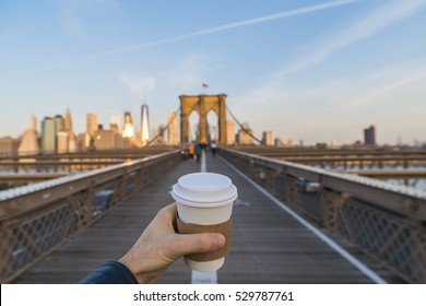 Hand holding coffee cup in New York City. - Powered by Shutterstock