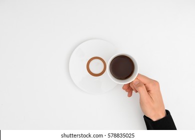 Hand Holding Coffee Cup On White Background. Top View