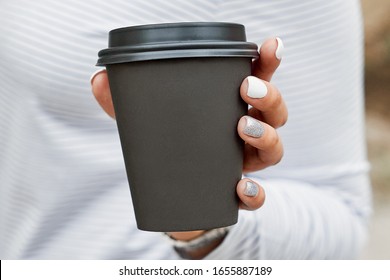 Hand Holding A Coffee Paper Cup On A Light Background