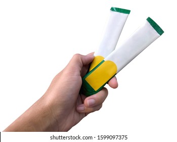 A Hand Holding A Coffee Sachet On White Background Isolated.