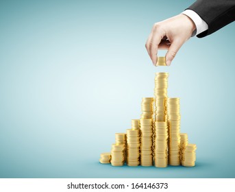hand holding coins and build coin graph - Powered by Shutterstock