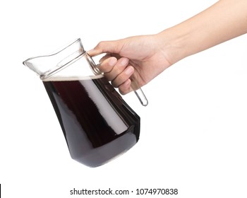 Hand Holding Cola In A Jug With Glass Isolated On A White Background