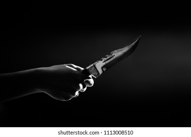 Hand Holding Combat Knife On A Black Background. / Crime Concept. /violence.
Selective Focus.