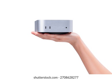 A hand holding a compact mini PC or portable computer isolated on a clean white background.