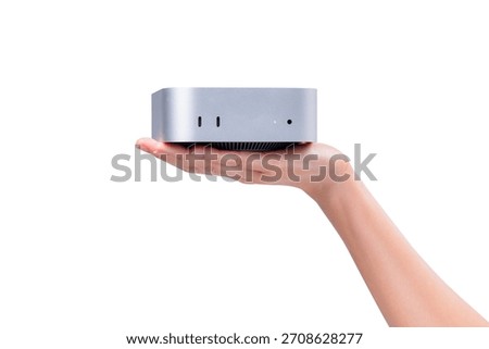 A hand holding a compact mini PC or portable computer isolated on a clean white background.