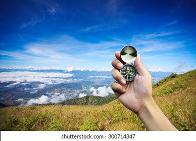 Hand Holding A Compass