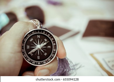 Hand Holding Compass.