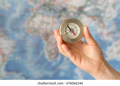 Hand holding compass on the background of map - Shutterstock ID 676066144