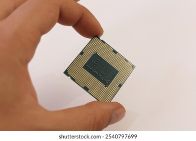 hand holding computer processor in isolated hand