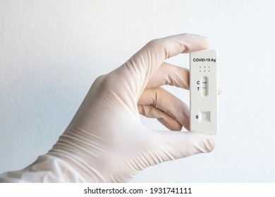 Hand holding coronavirus covid19 Ag positive test on a white background