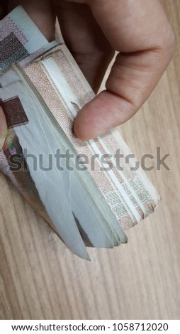 hand holding and counting money 