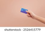 Hand holding credit card on isolated background.