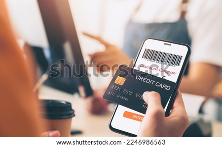 Hand holding credit card payment and using smartphone with scan barcode for discount code coupon, shopping online, Digital wallet concept.