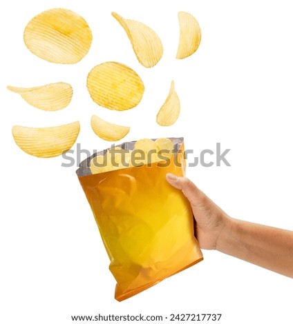 Hand Holding Crispy Potato chips fly out of yellow foil bag isolated on white background, Crispy Potato chips on white With clipping path.
