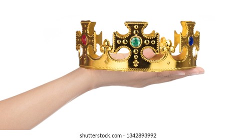 Hand holding crown golden isolated on a white background