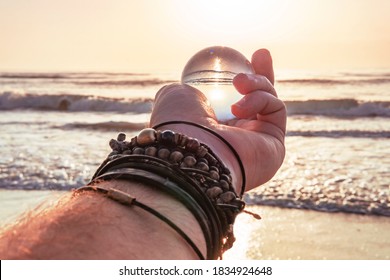 Hand Holding Crystal Ball On Ocean Travel Explore Beach Concept