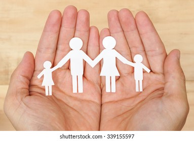 Hand Holding A Cutout Paper Chain Family