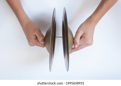 Hand Holding Cymbals, An Old Thai Musical Instrument Isolated On White Background.
