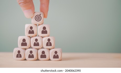 hand holding dart icon on wood block stack , strategy business method to target, brainstorming manpower to success, teamwork and business concept
