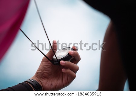 Hand holding the device Race timer