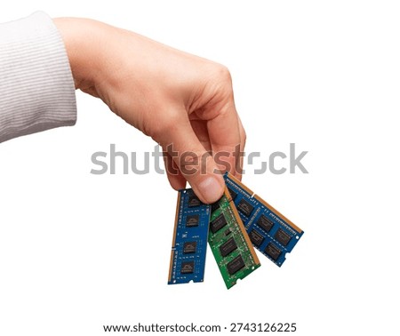 A hand is holding different computer memory sticks like DRAM, DDR, SODIMM, and DIMM, showing the diversity in hardware memory types.