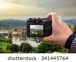 hand holding the Digital camera, shoot of landscape photo using liveview