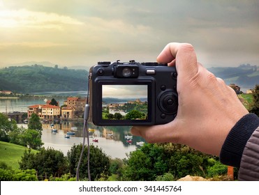 Hand Holding The Digital Camera, Shoot Of Landscape Photo Using Liveview