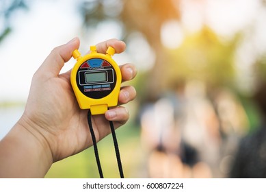 Hand Holding Digital Chronometer For Counting A Time - Copy Space On Chronograph For The Number That You Want