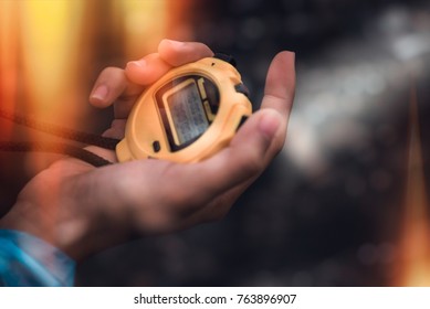 Hand Holding Digital Chronometer For Counting A Time