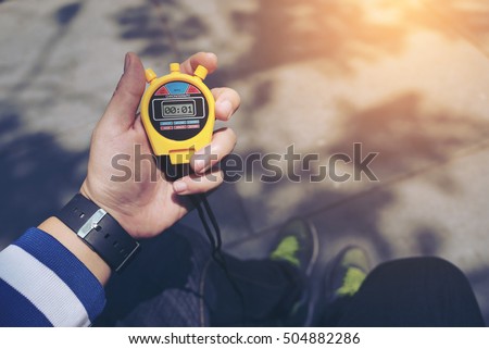 Hand Holding Digital Chronometer for Counting a Time