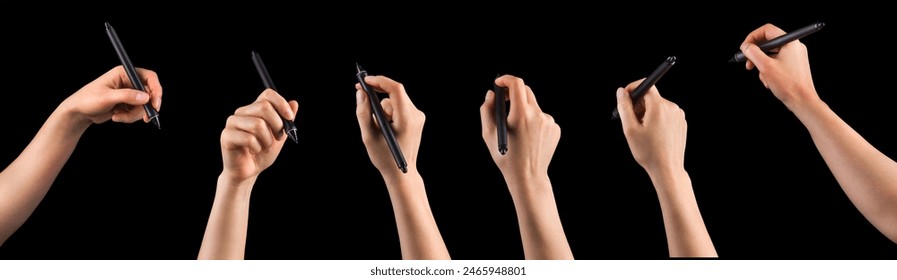 Hand holding digital graphic pen and drawing something isolated on black background with clipping path