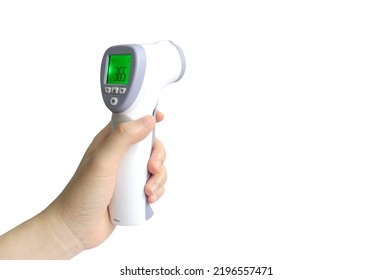 Hand  Holding A Digital Infrared Thermometer Gun With LCD Screen Showing Normal Body Temperature Scan For Coronavirus Disease COVID-19  Prevention, Health Care Concept, Isolated On White Background.