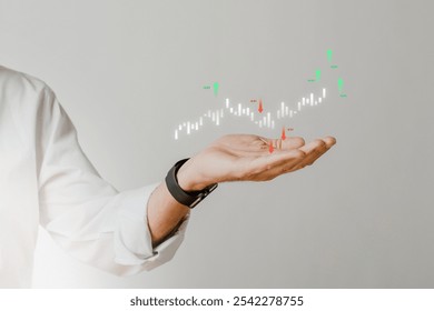A hand holding a digital stock chart. The stock chart floats above the hand, displaying financial data. Business concept with stock chart and hand. Finance and stock data concept graph.