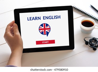 Hand holding digital tablet computer with online learn English concept on screen. All screen content is designed by me