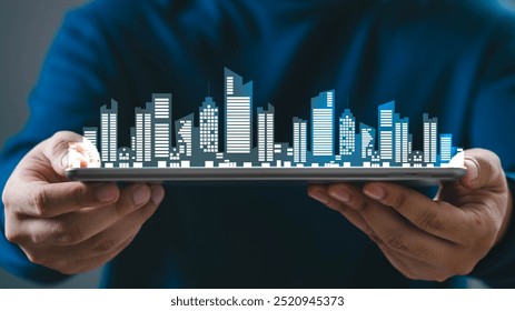 Hand holding a digital tablet with a virtual city skyline hologram. Concept of real estate, smart city, and modern urban technology. - Powered by Shutterstock