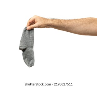 Hand Holding Dirty Socks Isolated. Laundry, Household Chores Concept, Smelly Sock, Sweaty Cotton Underwear, Used Dirty Socks On White Background