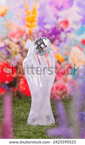 A Hand Holding a Disco Mirror Ball in a Beautiful Summer Spring Outdoor Floral Flower English Garden, Spring Fling Concept