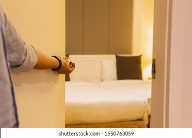 Hand Holding Door Knob, Opening Hotel Bedroom Door Selective Focus.