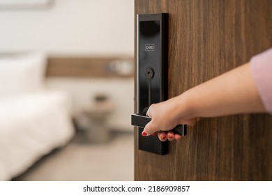 Hand Holding Door Knob, Opening Hotel Bedroom Door Selective Focus.