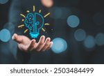 Hand holding drawing virtual lightbulb with brain on bokeh background for creative and smart thinking idea concept.