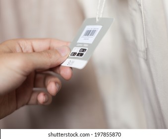 Hand Holding A Dress Tag In A Store