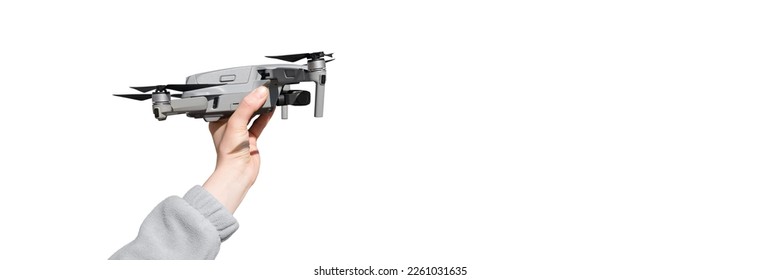 Hand holding drone ready to take off isolated on the whire background. Drone in hand - Powered by Shutterstock